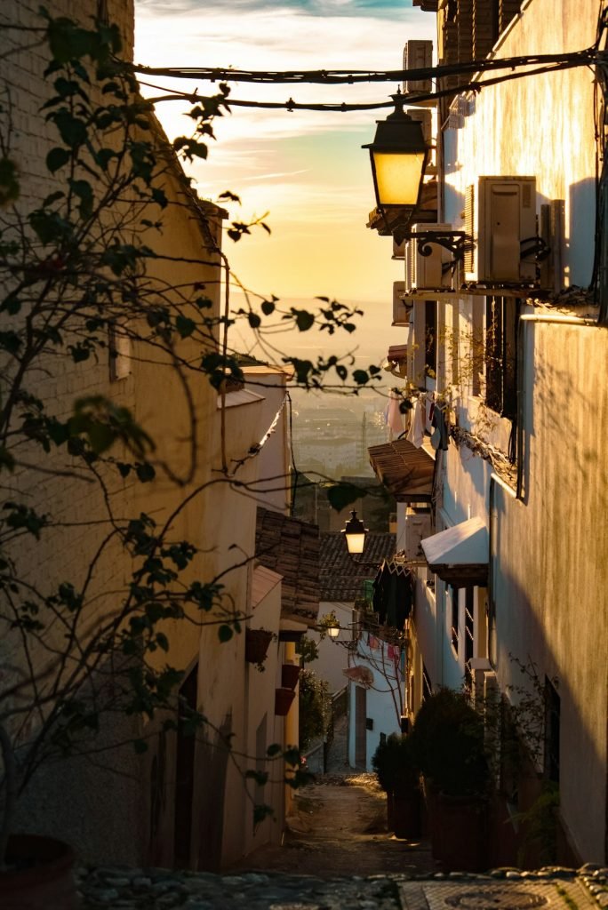 a-narrow-alley-way-with-a-street-lamp-and-a-view-of-the-ocean-yuqd-ydruww